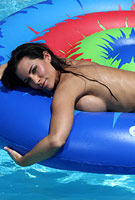 Laura Lee in sheer bikini spreading out on floating island
