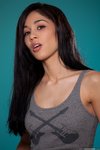 Aries Stone lifts off her grey top