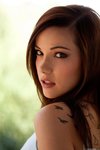 Elizabeth Marxs sits on a bench and takes off her top
