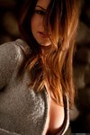 Amber Sym slides off her soft grey jacket