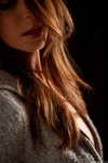 Amber Sym slides off her soft grey jacket