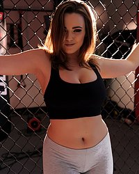 Jodie in the ring in her black top and gray leggings
