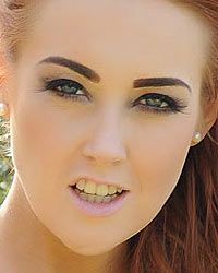 Lucy Anne in her tight green dress outdoors

