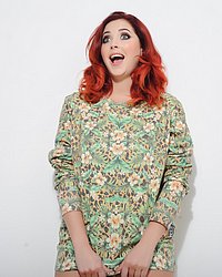 Lucy V teasing in her green floral print top and black thong

