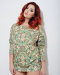 Lucy V teasing in her green floral print top and black thong
