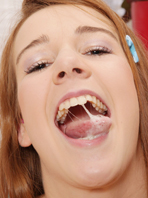 Liz - This photo series features Liz sucking cock upside down as her throat is restrained.