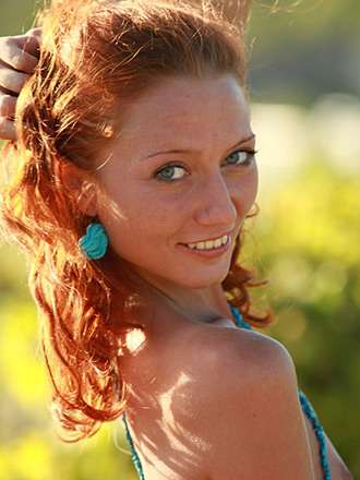 Innocent and sexy princess Kesy with curly hair is taking off her clothes outdoors