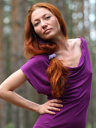Skinny redhead Kesy shows off her naked beauty in the forest