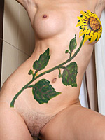 Stimulating Jasmin with sunflower painting on her nude and flat tummy
