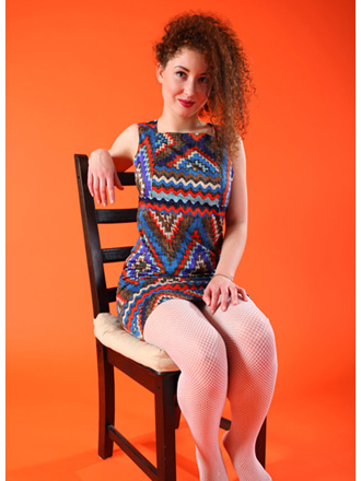 Daisy in zigzag dress and torn fishnet stockings with her cunt exposed