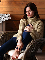 Tinka removes jeans in her comfy chair and shows tits under sweater
