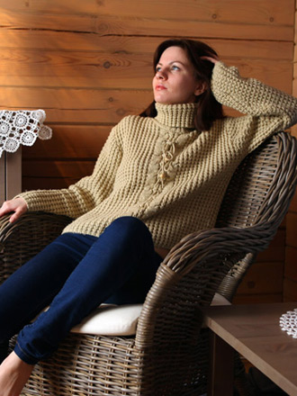Tinka removes jeans in her comfy chair and shows tits under sweater