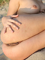 Busty Cecelia heat your imagination curving nude on the sand