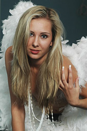 Stunning blonde girl with small breasts posing with angel wings
