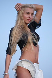 Blonde teen with shaved pussy takes off her white skirt outdoor