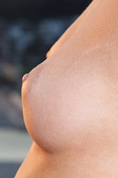 Tall perfectly shaped teen standing naked on the balcony of the hotel