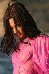 Brunette teen getting wet in the sea