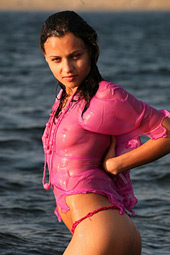 Brunette teen getting wet in the sea