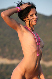 Very sexy brunette teen bending naked on the seastone