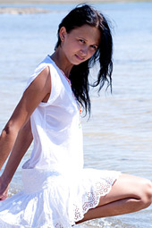 Sexy brunette teen posing bottomless on the beach
