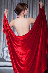 Seductive tramp teases with a swath of silky red cloth