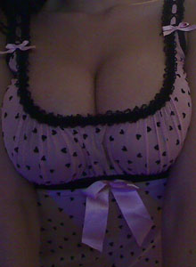 Sweet Krissy: Krissy shows off her big tits as she pulls them out of her little lingerie top and plays with them
