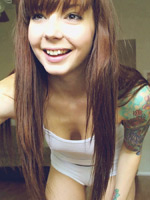 Ivy Snow pouring baby oil on her body on her webcam