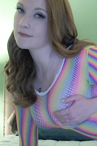 Lucy Ohara wears a skin tight rainbow dress and white high heels as she cums hard with her dildo