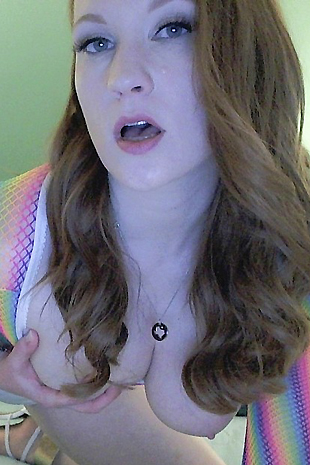 Lucy Ohara wears a skin tight rainbow dress and white high heels as she cums hard with her dildo