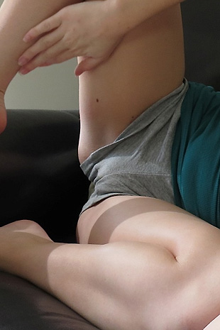 Madison Lain strips out of her casual clothes on her love seat and strokes her petite body