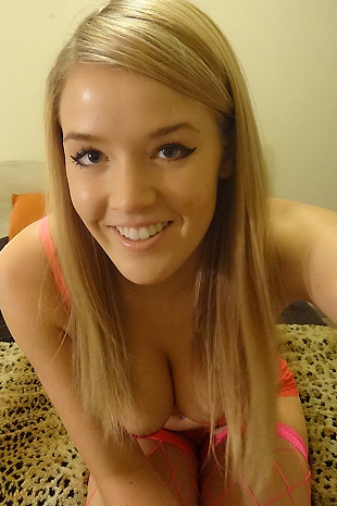 Sophia Winters wears pink fishnets while she cums hard on her bed