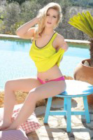 Jess Davies shows off her natural busty breasts by the pool