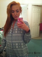 Lucy Anne peels off her grey onesie at home