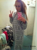 Lucy Anne peels off her grey onesie at home