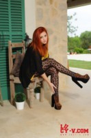 Lucy V strips from her black and yellow top and leopard print tights
