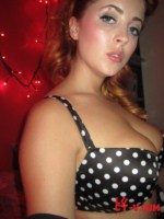 Lucy V shows off her busty breats from her polka dot outfit