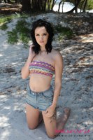 Mellisa Clarke strips from her boob tube and shorts at the beach