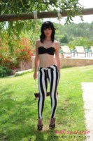 Mellisa Clarke plays on the swing and strips from her lingerie and stripe tight pants